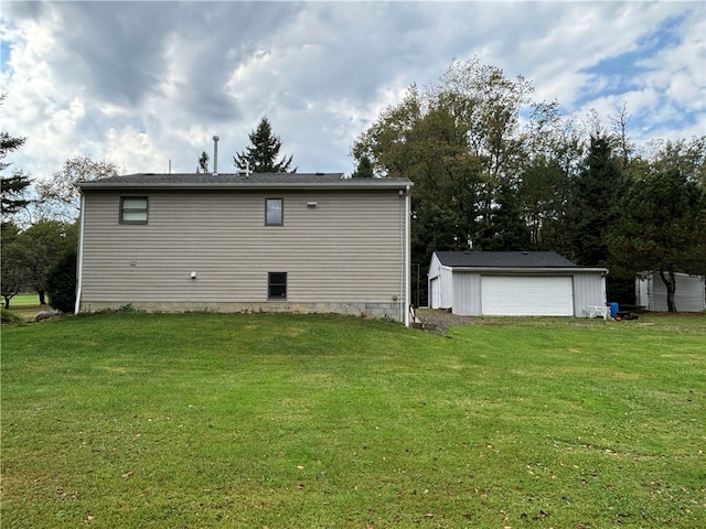 back of house featuring an outbuilding, a yard, and a garage