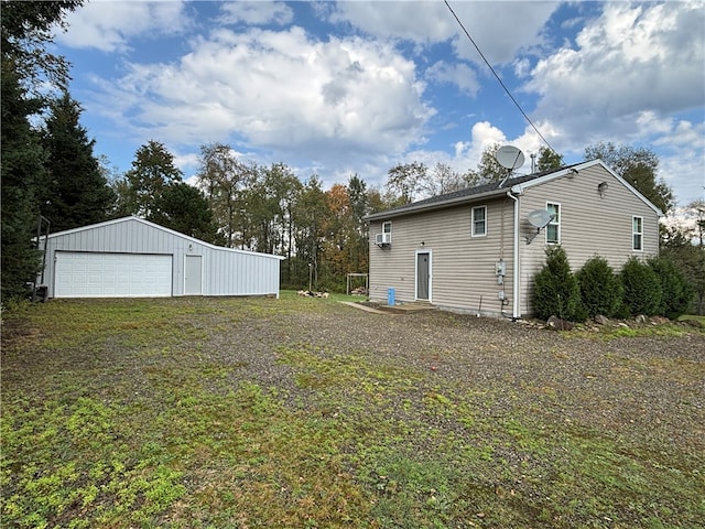 exterior space with a garage and an outbuilding