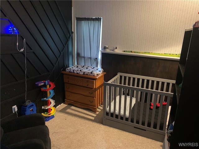 carpeted bedroom with a crib