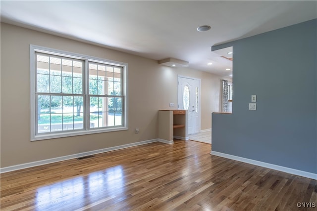 unfurnished room with hardwood / wood-style floors