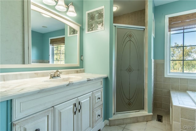 bathroom featuring tile patterned flooring, vanity, and plus walk in shower