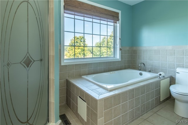 bathroom with tile patterned flooring, toilet, and plus walk in shower