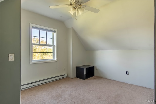 additional living space featuring lofted ceiling, light colored carpet, baseboard heating, and ceiling fan