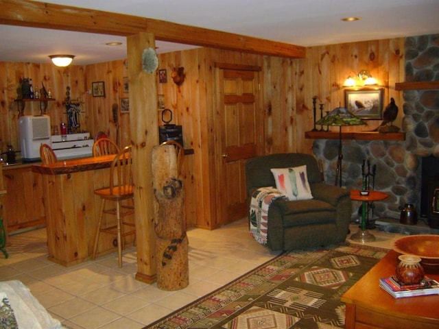 tiled living room featuring bar area, beamed ceiling, and wooden walls