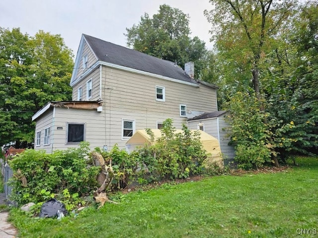 view of side of property with a yard