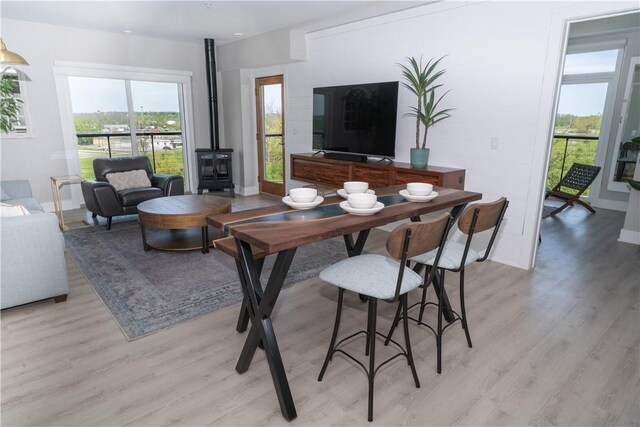 205 Lakeshore Dr Unit 520, Canandaigua City, NY 14424 - living area with a wood stove, light wood-style flooring, and healthy amount of natural light