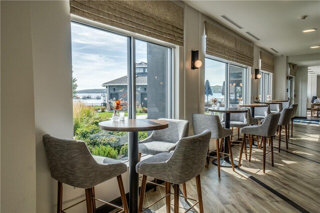 205 Lakeshore Dr Unit 520, Canandaigua City, NY 14424 - dining room with healthy amount of natural light, a water view, wood finished floors, and recessed lighting