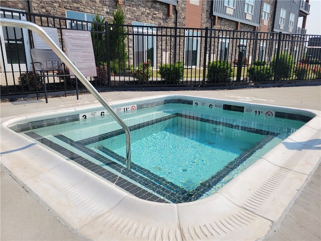 view of pool featuring a hot tub