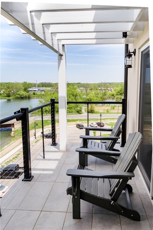 exterior space featuring a balcony and a water view