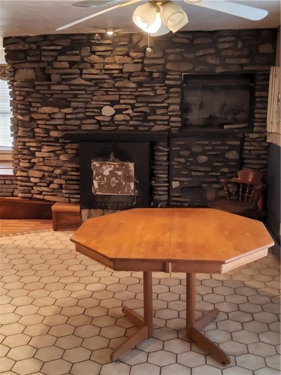 unfurnished dining area with ceiling fan and tile patterned floors