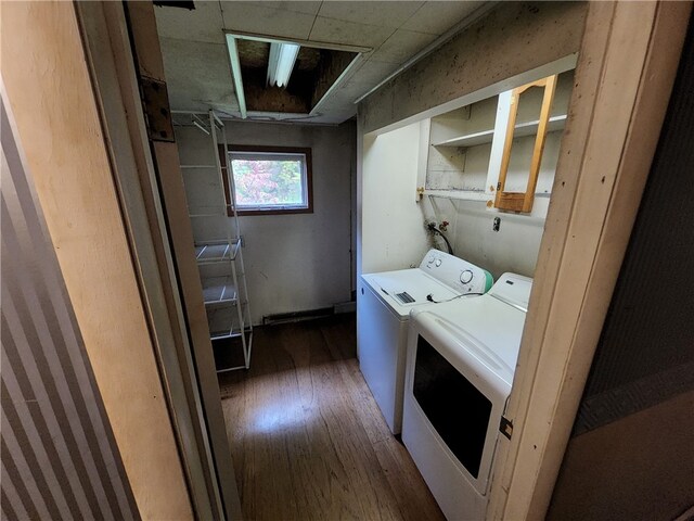 laundry room with separate washer and dryer and dark hardwood / wood-style flooring