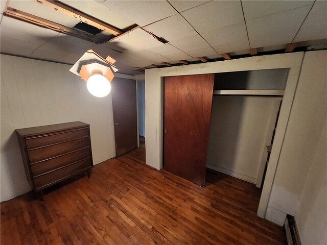 unfurnished bedroom with a closet and dark hardwood / wood-style flooring