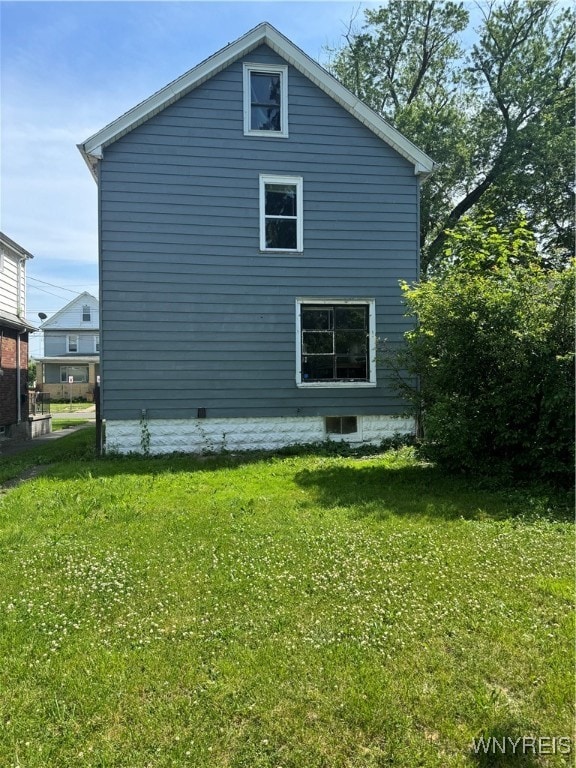 view of side of property with a yard