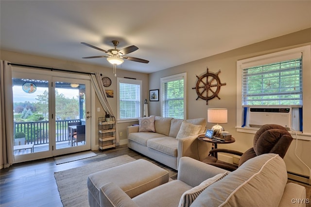 living room featuring a healthy amount of sunlight, a baseboard heating unit, ceiling fan, and hardwood / wood-style flooring