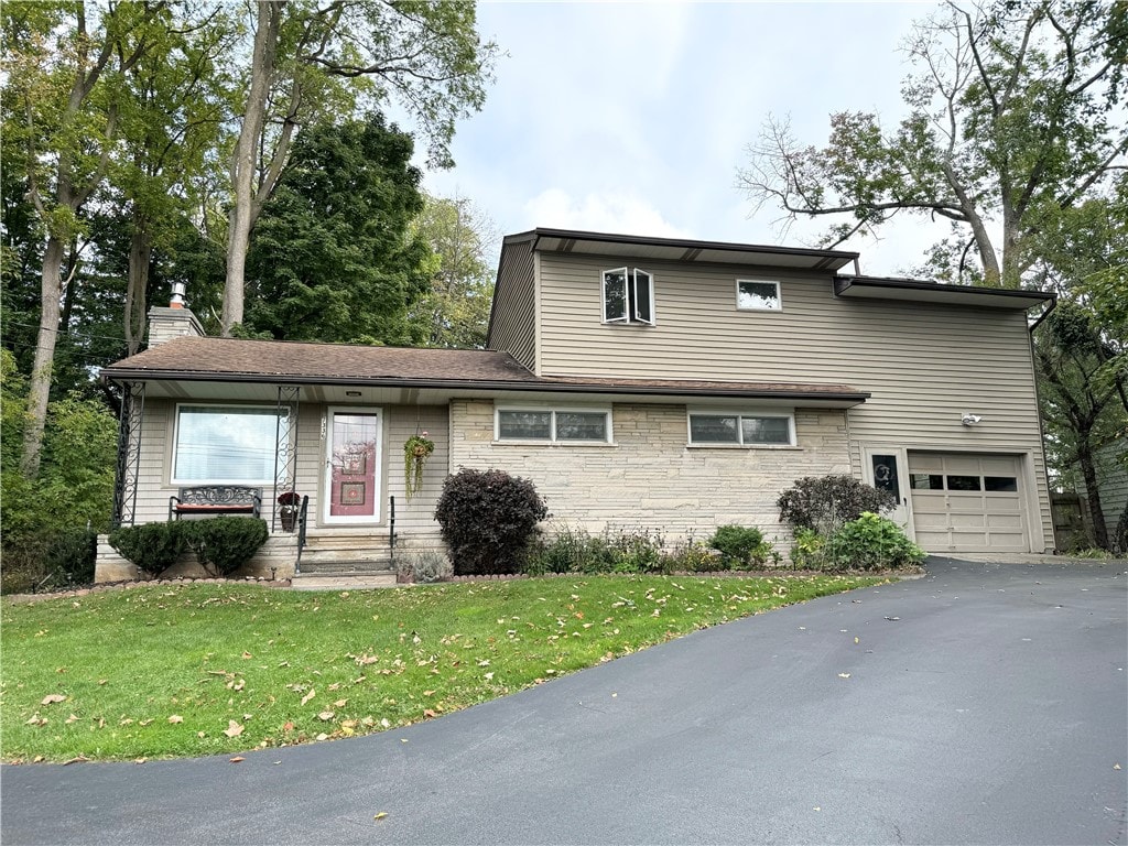 view of front of property with a front yard and a garage