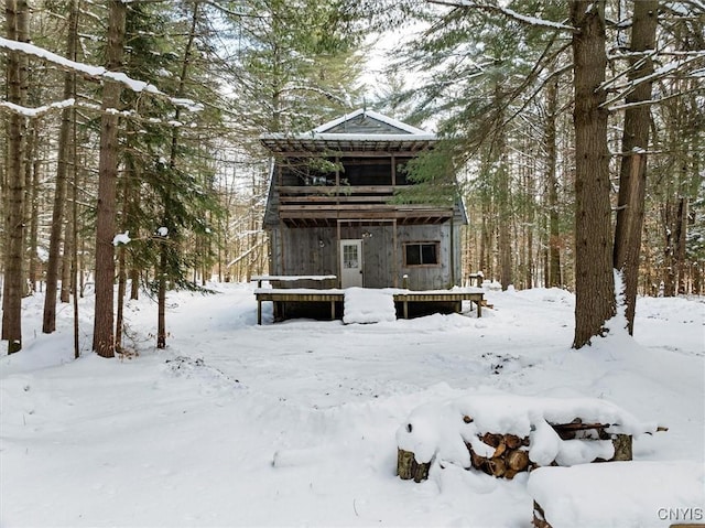 view of snow covered rear of property