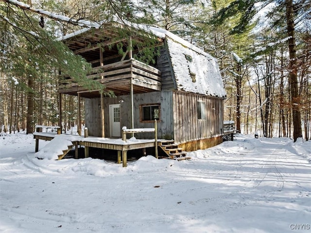 view of snow covered exterior with a deck