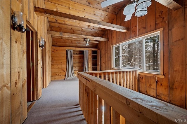 corridor featuring vaulted ceiling with beams, carpet floors, wooden ceiling, and wooden walls