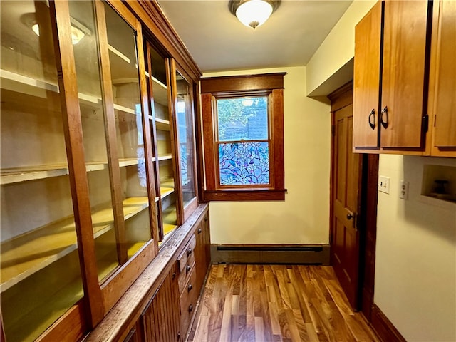 mudroom featuring a baseboard heating unit and light hardwood / wood-style flooring