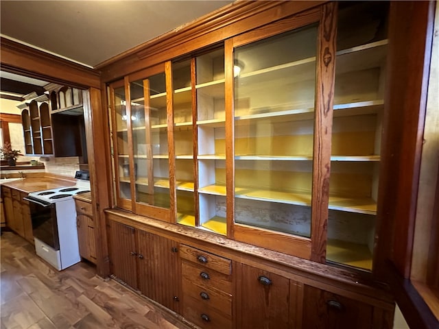 bar with wood-type flooring and white electric stove