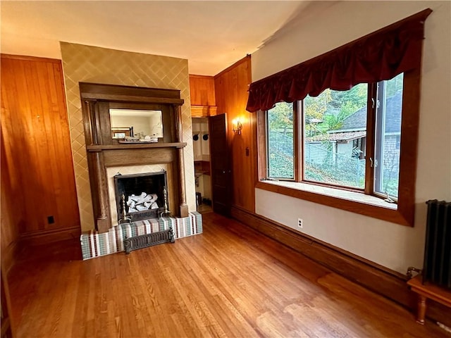 247 W Corydon St, Bradford-Town, PA 16701 - unfurnished living room featuring a fireplace, wood finished floors, baseboards, and radiator heating unit