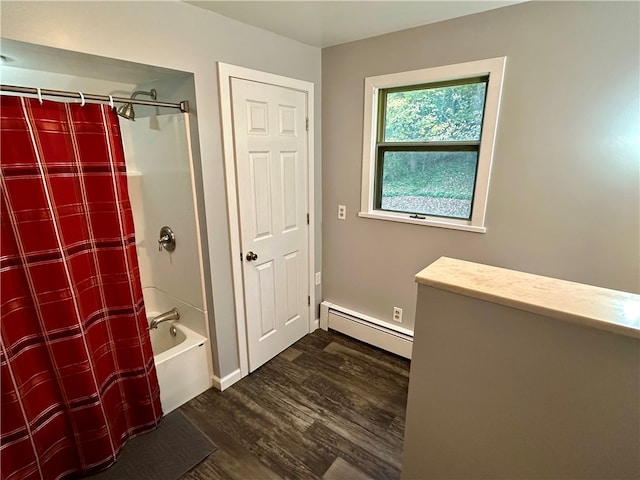 bathroom featuring baseboard heating, hardwood / wood-style flooring, and shower / tub combo