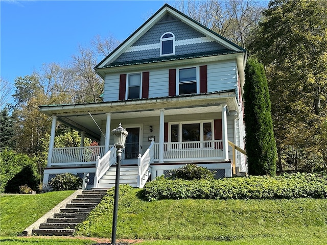 view of front facade with a porch and a front yard