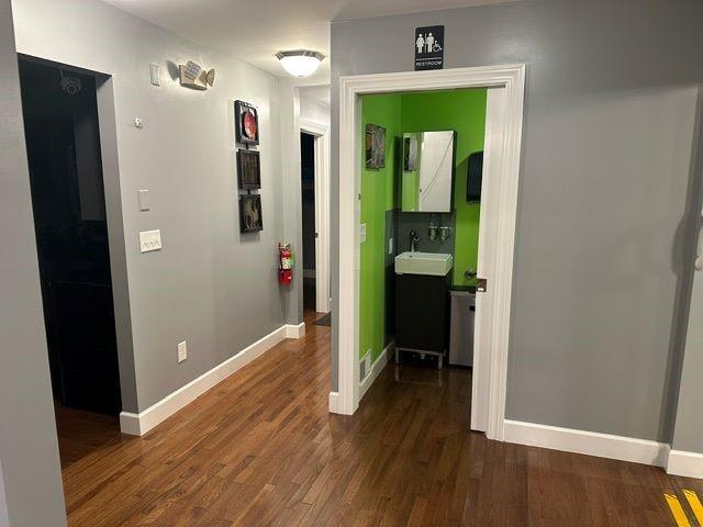 hall featuring sink and dark hardwood / wood-style floors