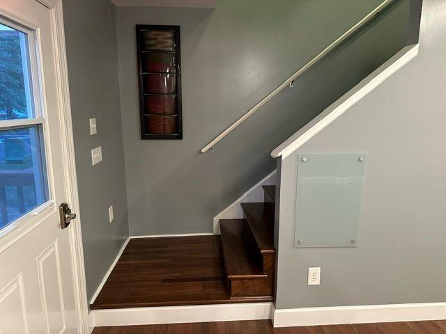 stairs featuring hardwood / wood-style flooring