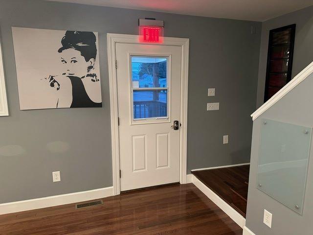 entryway with dark hardwood / wood-style flooring