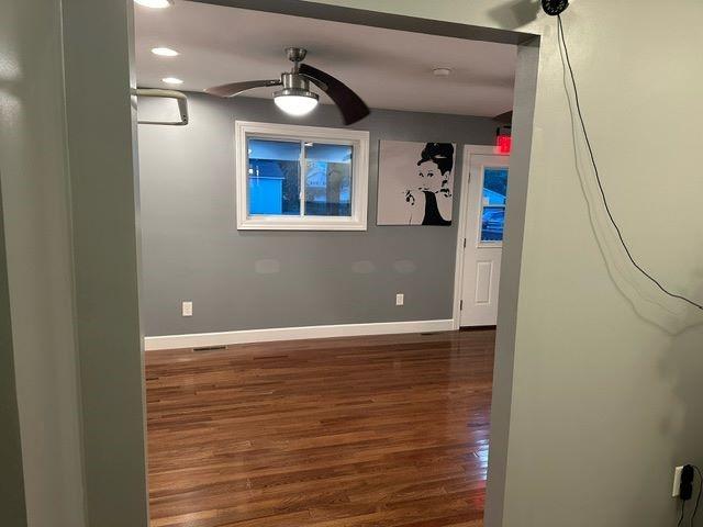 unfurnished room featuring ceiling fan and dark hardwood / wood-style floors