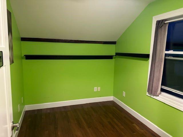 bonus room featuring vaulted ceiling and hardwood / wood-style flooring