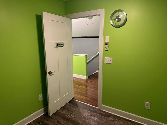 corridor with dark wood-type flooring