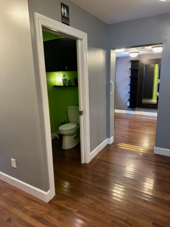 hallway with dark hardwood / wood-style flooring