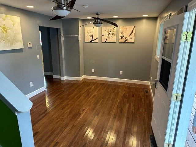 interior space featuring ceiling fan and dark hardwood / wood-style flooring