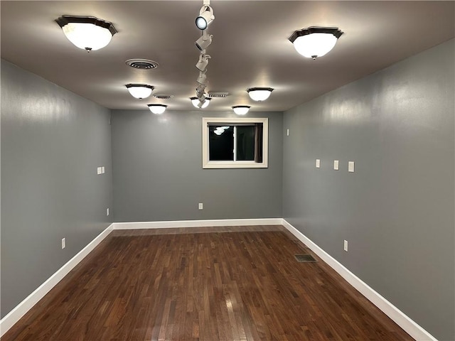 basement with dark hardwood / wood-style flooring