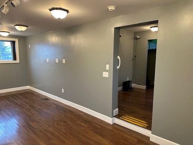 empty room with dark wood-type flooring