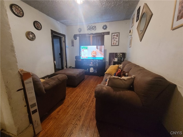 living room featuring a textured ceiling and hardwood / wood-style flooring