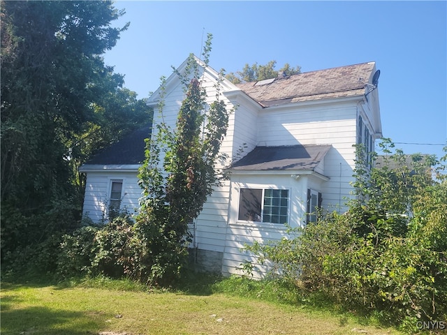 view of side of home featuring a yard