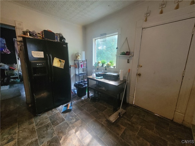 kitchen featuring black refrigerator with ice dispenser