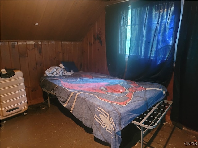 bedroom featuring wooden walls and vaulted ceiling