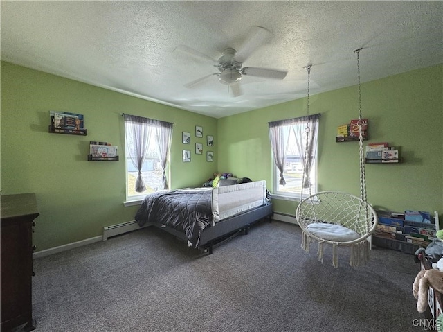 bedroom with multiple windows, carpet, and a baseboard heating unit