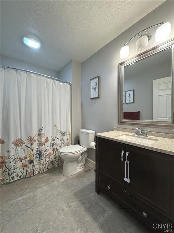 bathroom featuring vanity, toilet, a textured ceiling, and a shower with shower curtain