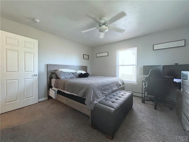 bedroom featuring a textured ceiling, dark colored carpet, and ceiling fan