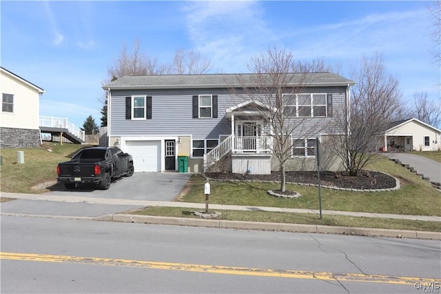 bi-level home featuring a garage and a front yard