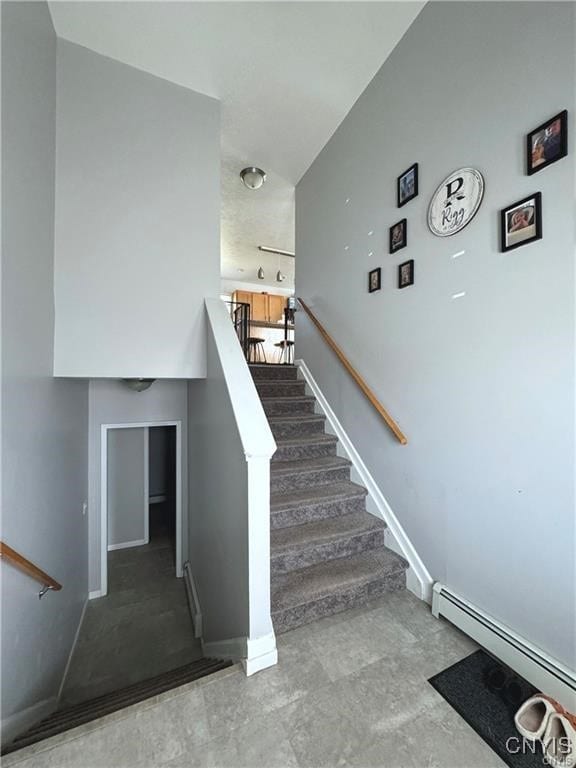 stairway with a baseboard heating unit