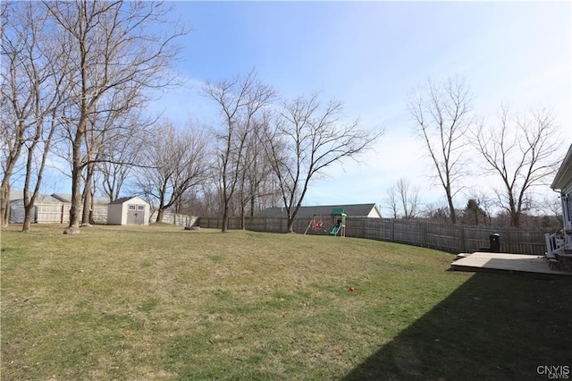 view of yard with a deck and a storage shed