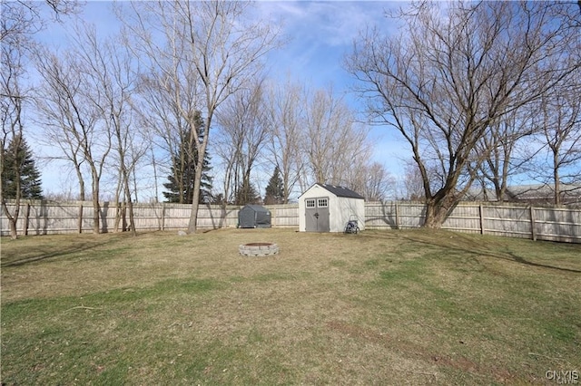 view of yard with a fire pit and a shed