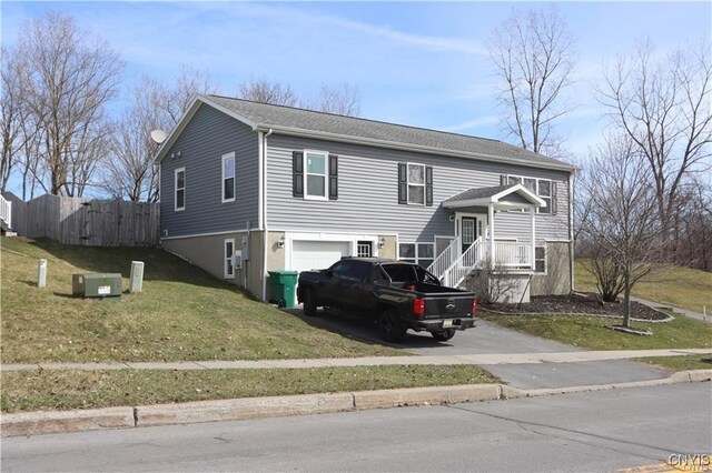 split foyer home featuring a garage and a front lawn