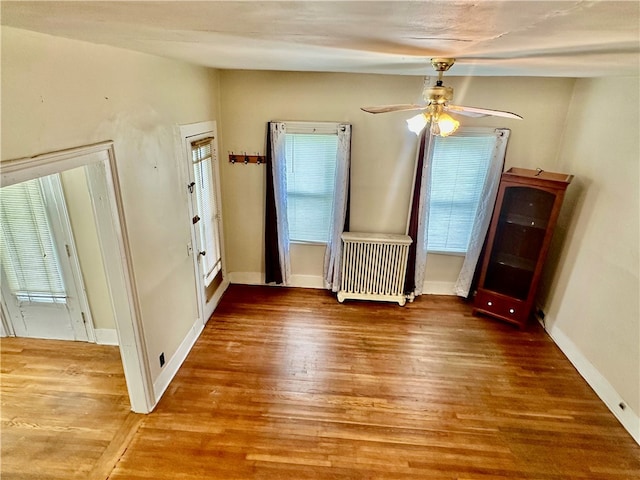 interior space with ceiling fan and hardwood / wood-style flooring